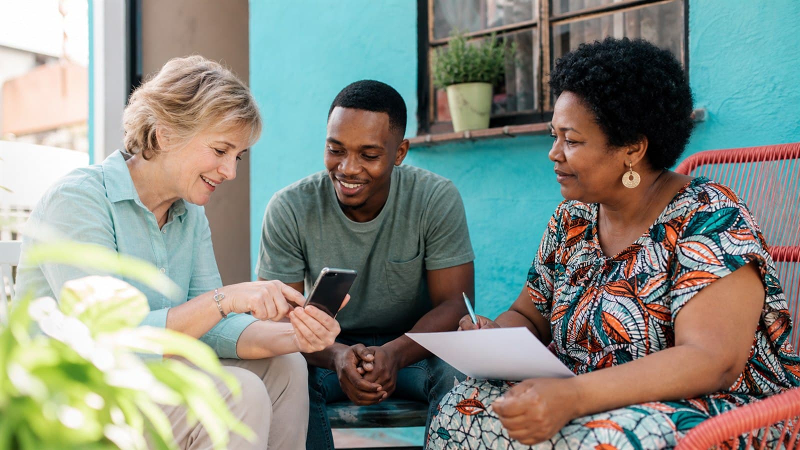Stokvel committee comparing South African group bank account options on a laptop