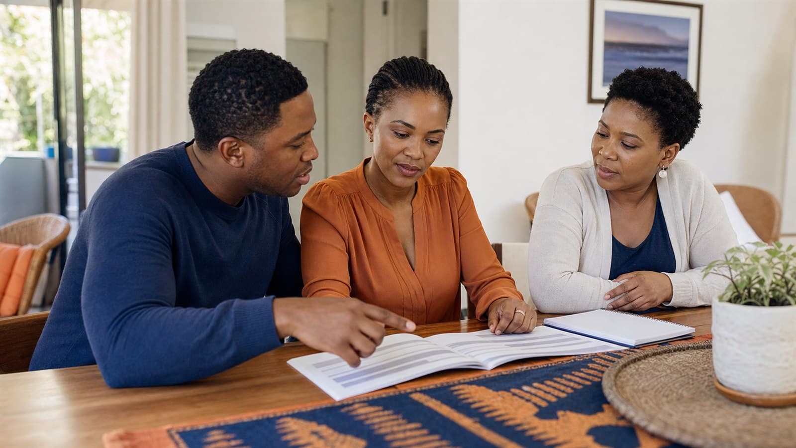 A new stokvel member reviewing scheme rules with two committee members